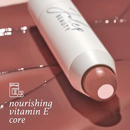 Lip balm with nourishing vitamin E core on glossy surface
